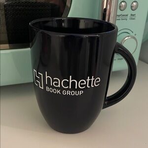 Ceramic mug with the white Hachette Book Group logo.
